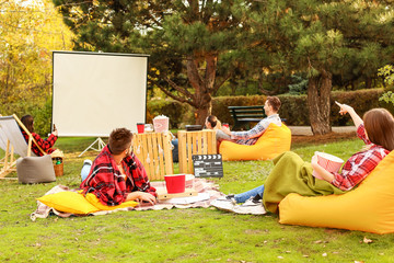 Canvas Print - Friends watching movie in outdoor cinema