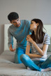 © SHOTPRIME STUDIO - young couple sitting on sofa and talking on cell phone