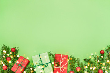 Christmas background. Gift boxes and Christmas decoration on green background. Top view, copy space.