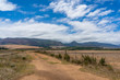 © Olga K - Countryside landscape with unsealed dirt road and mountains