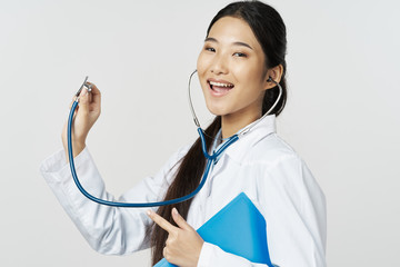 Wall Mural - young doctor with stethoscope isolated on white