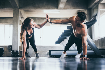 personal trainer coach helping young woman exercising in the sport gym, exercise training workout in