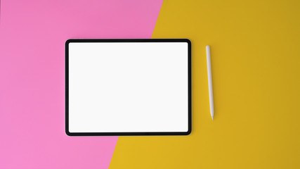 Wall Mural - top view of modern workplace with blank screen tablet on yellow and pink desk