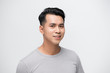 © makistock - Smiling young handsome Asian man face studio shot isolated