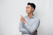 © makistock - Young asian man over isolated white background surprised pointing with finger to the side