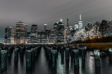 Long exposure old pier Brooklyn pylons looking out at downtown Manhattan