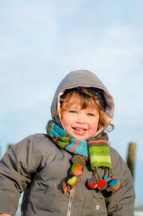 Wall Mural - beautiful little girl on the beach in winter