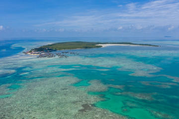 Aerial view of Sea Gypsy water village, island and the ocean with sky in Semporna, Sabah, Malaysia, Borneo.