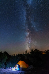 Wall Mural - vertical landscape images with a night starry sky and a milky way against the backdrop of a yellow t