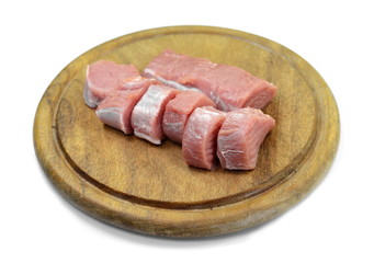 Sticker - Fresh raw beef meat slices on a round wooden board isolated over white background