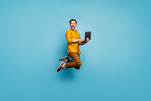 Full Size Photo Of Funky Man Feel Rejoice Emotions Jump Use Laptop Search Social Media Online Black Friday Discounts Wear Casual Style Clothing Isolated Over Blue Color Background