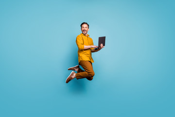 full size photo of funky man feel rejoice emotions jump use laptop search social media online black 