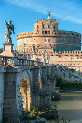 Rome, Italy - October 9, 2019 - view of the sculptures of angels and the castle of the Holy Angel on a background of blue sky.