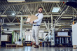 © Dusan Petkovic - Smiling caucasian bearded graphic engineer in shirt and tie walking in printing shop and relocating box. In background are printing machines.