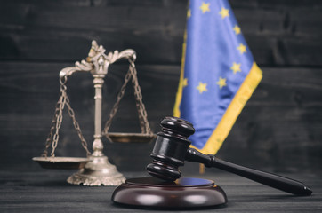 Wall Mural - Scales of Justice, Judge Gavel and Flag of the European Union on a wooden background.