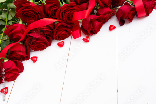 Red blooming roses on wood