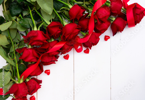 Red blooming roses on wood