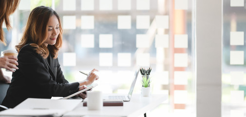 Young professional asian businesswoman working on her project in modern office