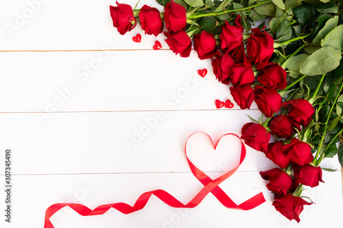 Red blooming roses on wood