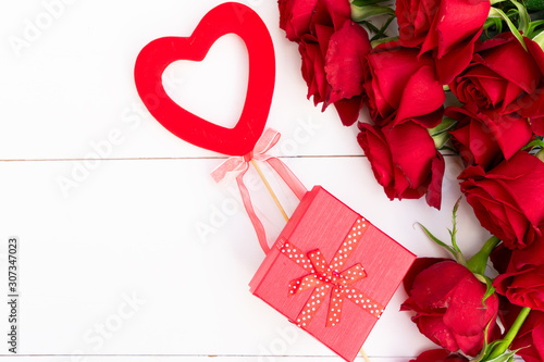 Red blooming roses on wood