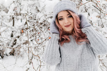 Young Blonde Woman In Gray Sweater Is Enjoying Winter