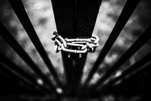 High Angle Gray Scale Shot Of The Metal Gate Locked With A Chain