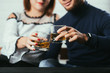 © komokvm - Young couple guy and girl drink whiskey on a date