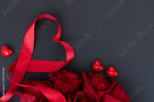 Red blooming roses on wood