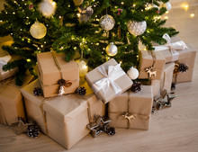 Close Up Of Beige Gift Boxes Under Decorated Christmas Tree