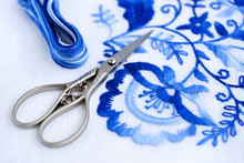 Embroidery, Thread And Scissors. Blue Floral Ornament On A White Background. Art And Craft Conception.