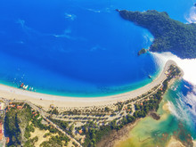 Amazing Aerial View Of Blue Lagoon In Oludeniz, Turkey. Summer Landscape With Sea Spit, Green Trees, Azure Water, Sandy Beach In Bright Sunny Day.