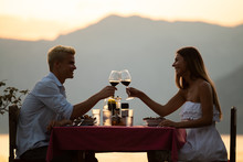 Couple Sharing Romantic Sunset Dinner On Tropical Resort