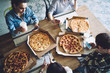 © BullRun - Variety of pizza on table for friends surfing smartphone