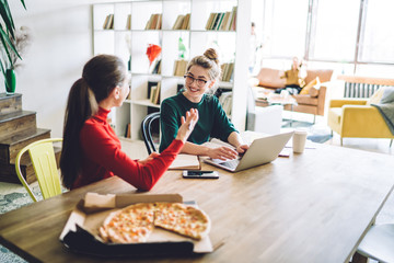 Cheerful student discussing assignment at home