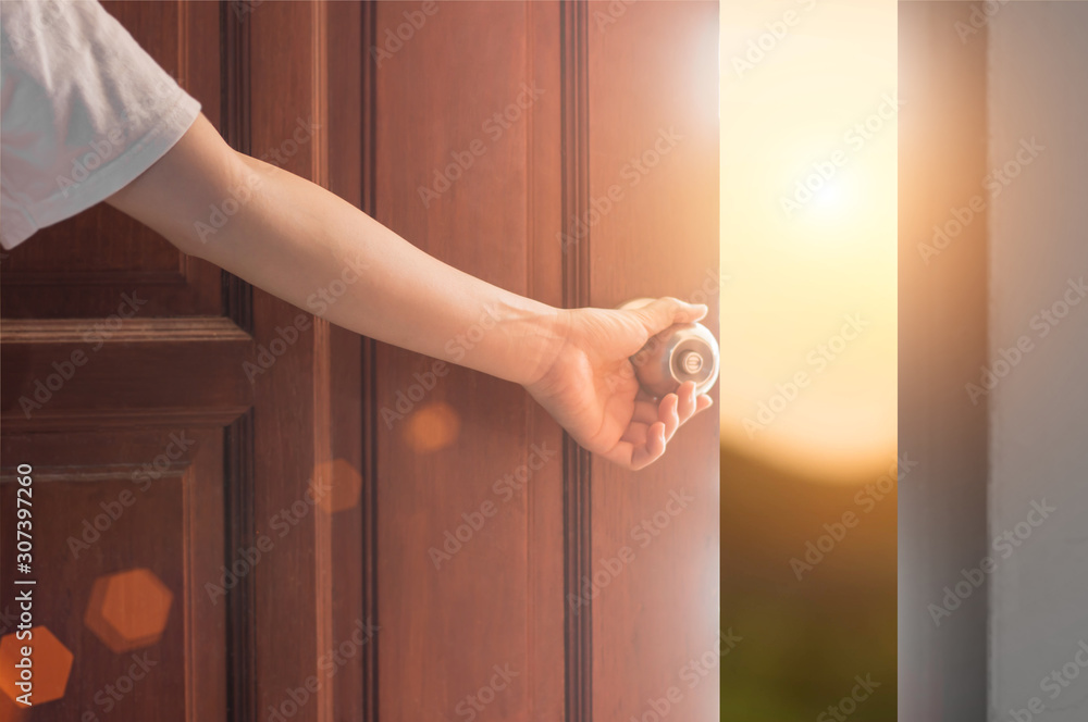 Women hand open door knob or opening the door,grand opening,Close up hand open door. - obrazy, fototapety, plakaty 