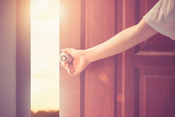 Wall Mural - Women hand open door knob or opening the door,grand opening,Close up hand open door.