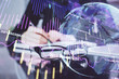 © peshkova - Forex chart hologram on hand taking notes background. Concept of analysis. Double exposure