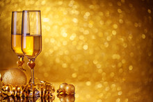 Champagne Glasses On A Beautiful Bokeh Background. Happy New Year. Christmas And New Year Holidays Background, Winter Season. Background With Copy Space.