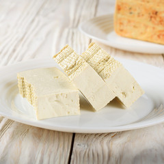 Poster - Soy Bean curd tofu on clay dish closeup. Non-dairy alternative substitute for cheese