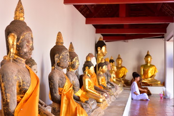 Golden statue of buddha in temple, Thailand