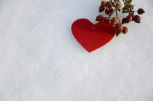 Winter. December. On White Snow Are Sprigs Of Vitamin Dried Orange Rose Hips And A Red Felt Heart.