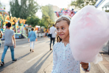 Girl Holding Cotton Candy On Street