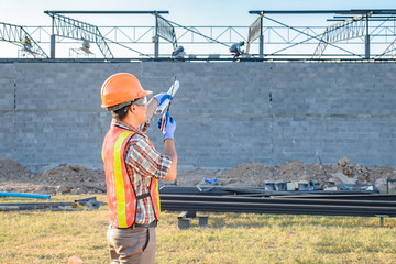 Wall Mural - A construction worker Currently ordering workers Site area With radio communication