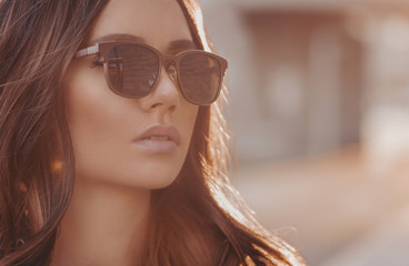 Wall Mural - Beautiful young woman in sunglasses in outdoor