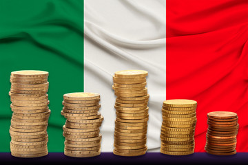 child, boy, in a white doctor’s coat, hat and mask attached a stethoscope to a red heart model, Italy flag background, close-up, face focus, medical concept, cardiology, copy space