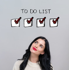 Poster - To do list with happy young woman on a gray background