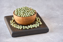 Bowl Of Dried Green  Peas On Wooden Board    
