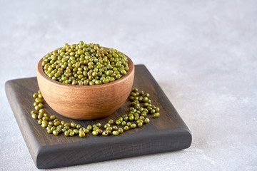 Wall Mural - Bowl of dried mung bean on wooden board    