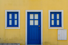 Beautiful Blue Gate And Windows With A Yellow Facade