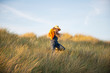 © Johnér - Girl walking through grass